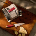 A top down view of the sharpener and knife on a wooden cutting block in the kitchen