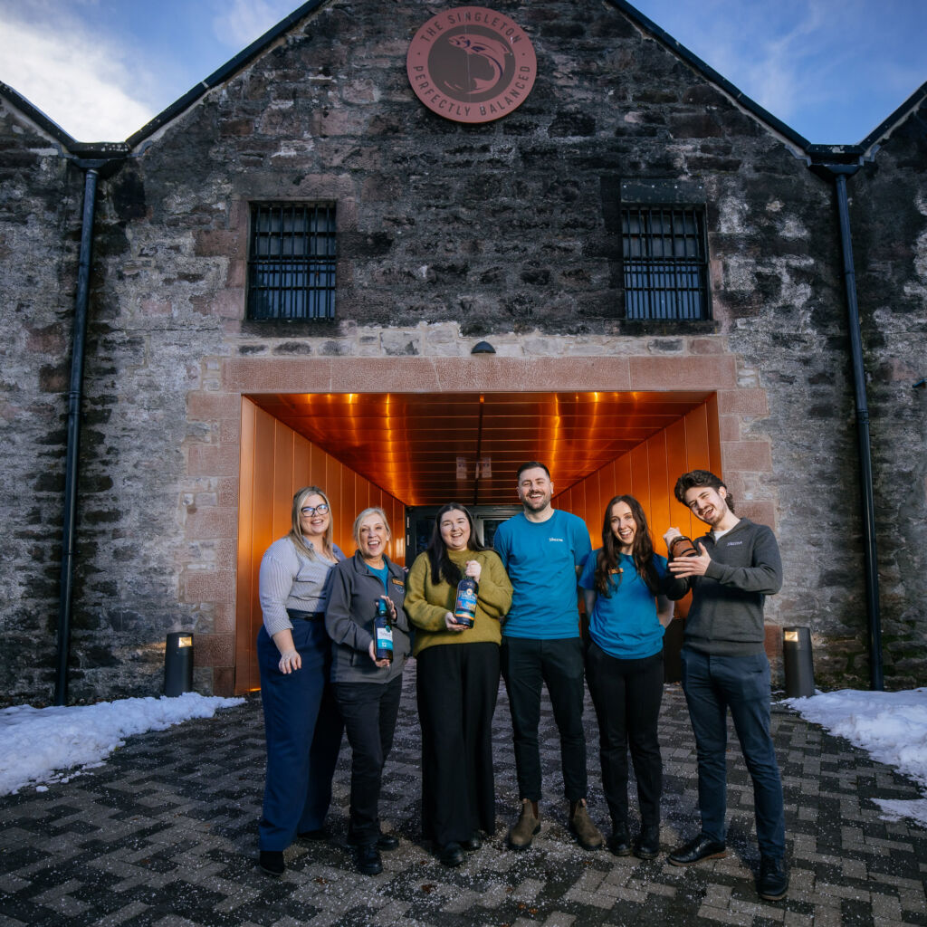 Members of the team standing outside the distillery building