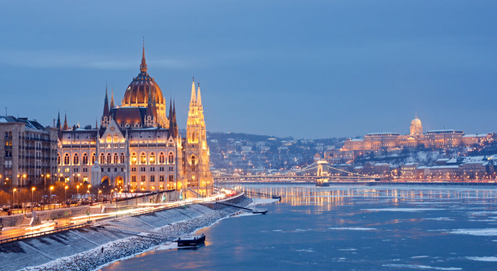 A photograph of the Parliament building in winter at night