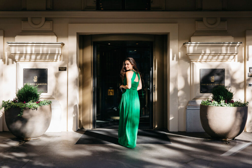 A female guest in a green dress entering the hotel