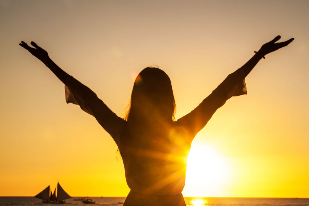 A woman celebrating the sun rising