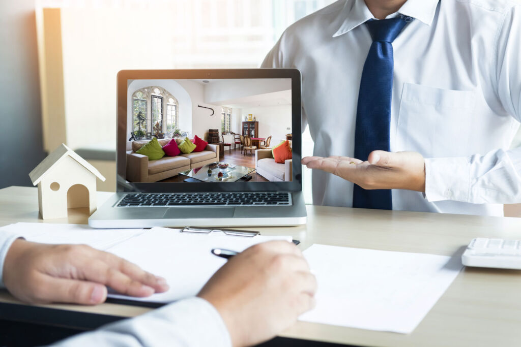 An estate agent showing a property on a computer