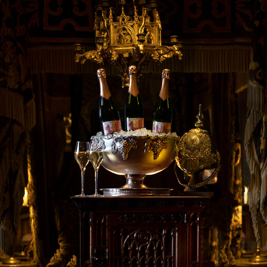 Three bottles of bubbly with full glasses