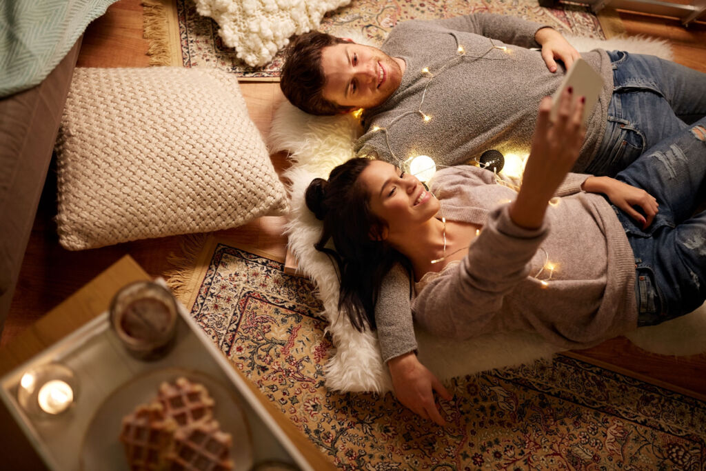 A couple relaxing on the floor of their home