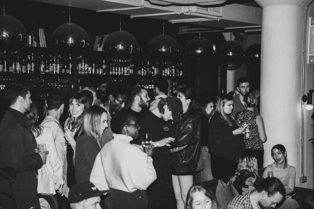 A black and white photograph of guests enjoying the venue