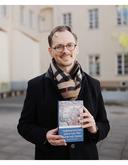 The award winning author holding a copy of his book