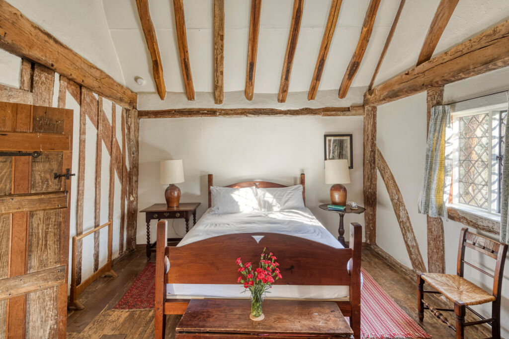 The wooden beamed bedroom in Hole Cottage