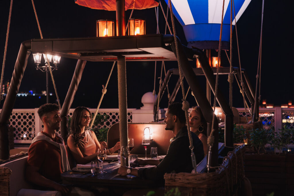 Guests sitting in one of the balloons at night