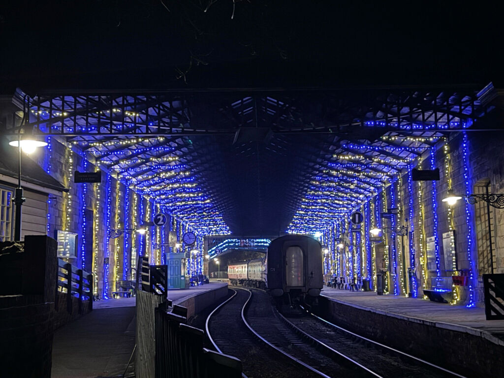 A train entering the festive themed station