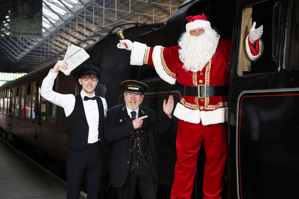 Santa, the conductor and ticket master ready to greet guests