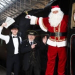 Santa, the conductor and ticket master ready to greet guests