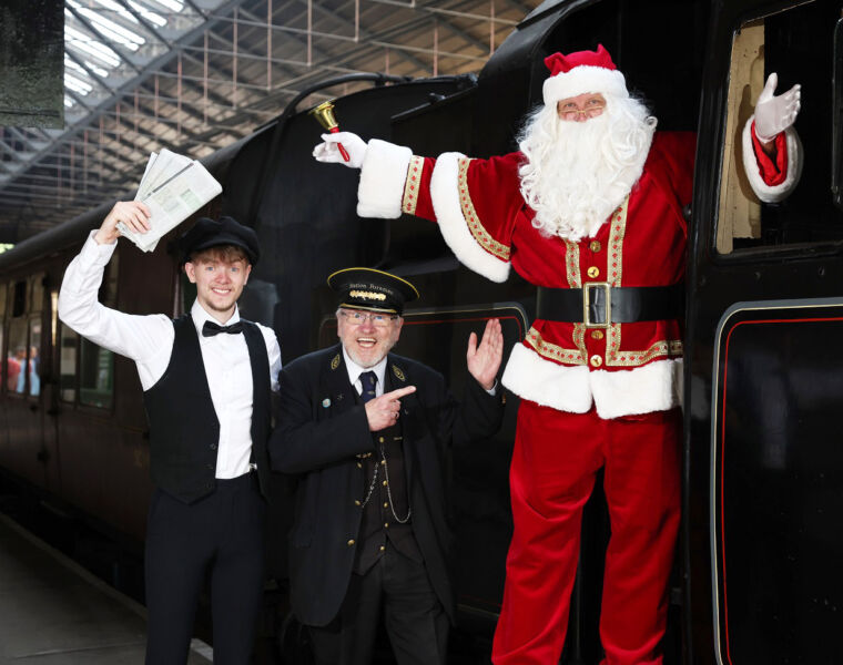 Santa, the conductor and ticket master ready to greet guests