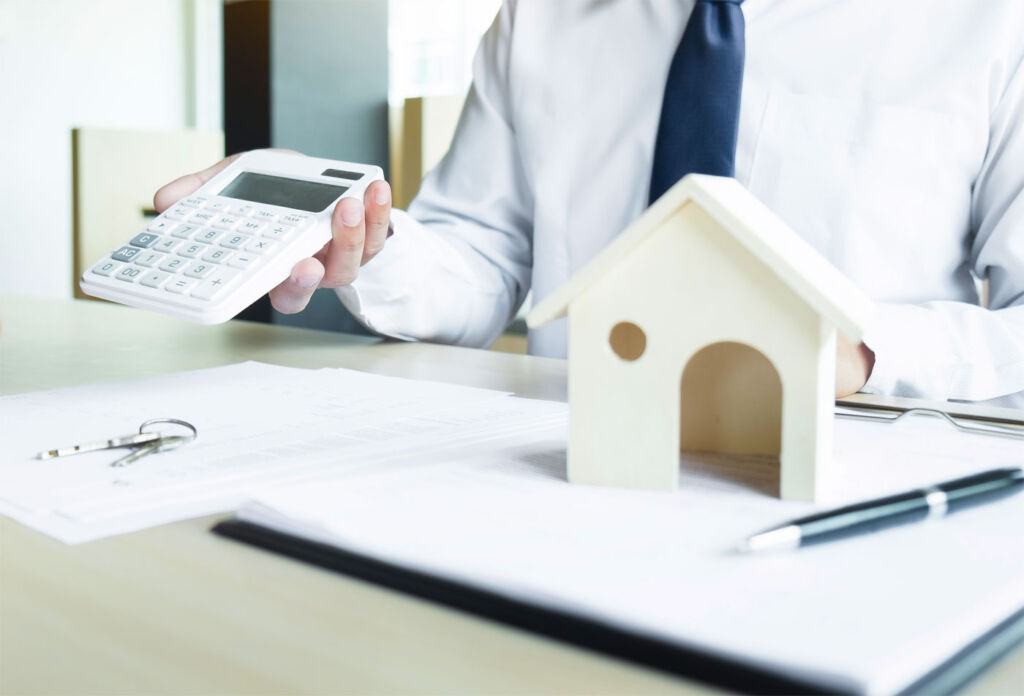 A mortgage adviser showing costs on a calculator