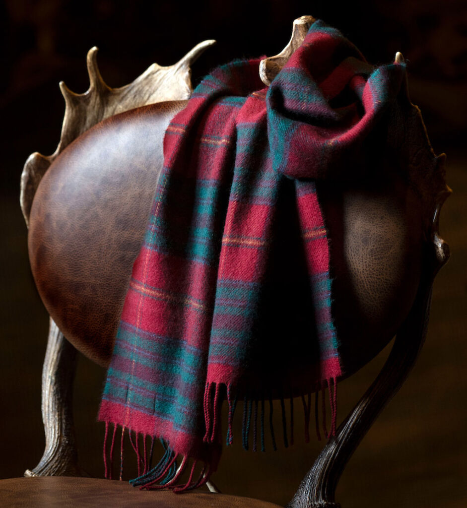 A tartan scarf draped over a leather chair