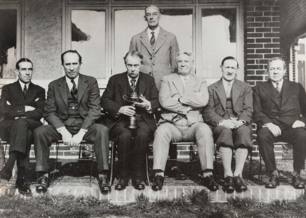 A black and white photograph of Ryder holding the trophy he created