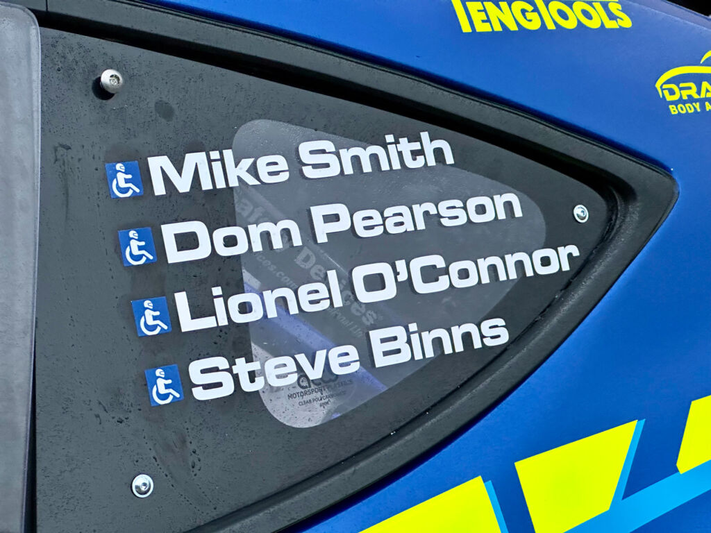 A list of the drivers name on the car window