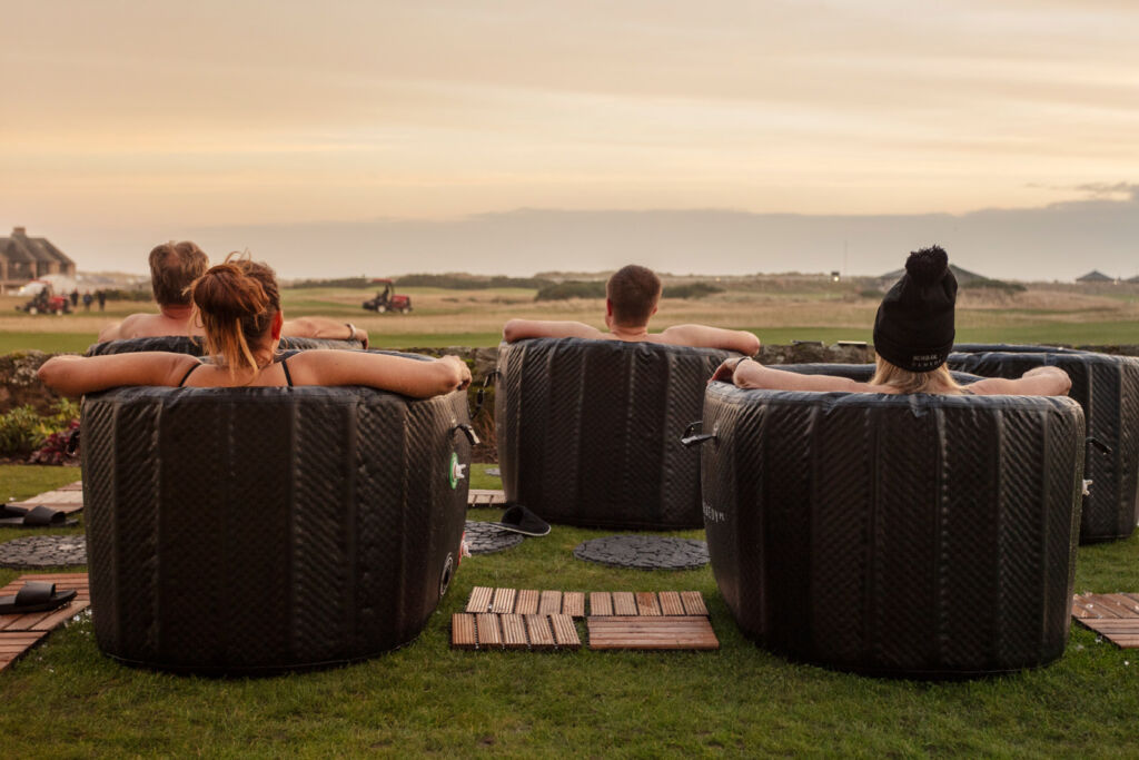 People enjoying the spa tubs on the beach