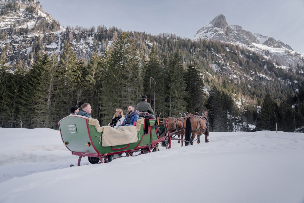 Guests enjoying a sleigh ride in the snow