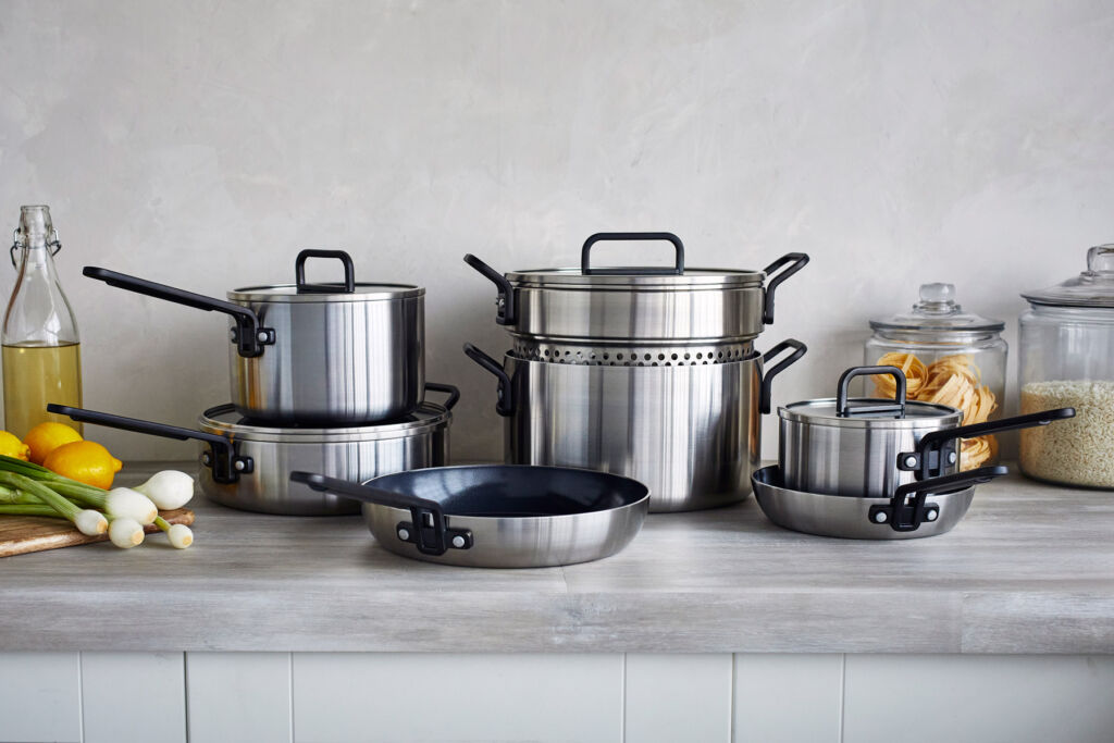 The collection in stainless steel with black handles