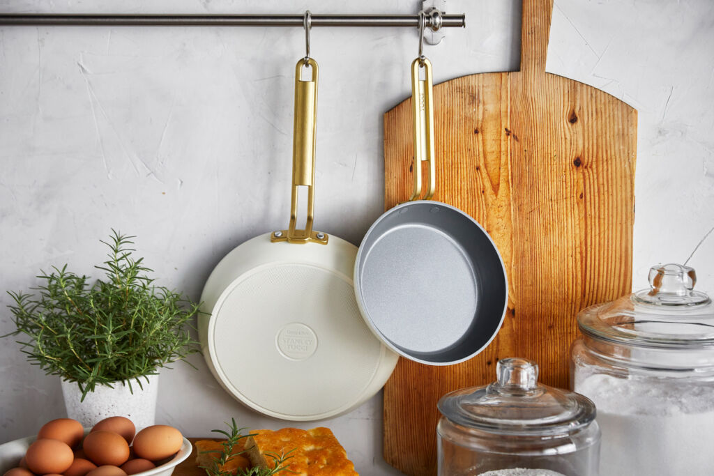 Two Carrara White frying pans hanging in the kitchen