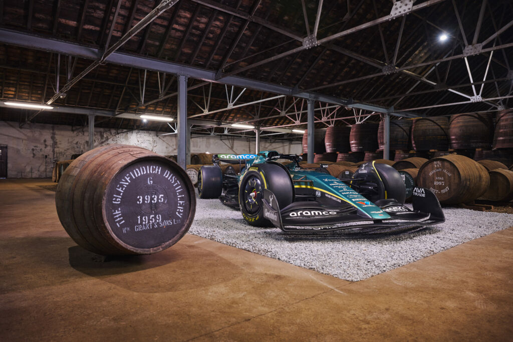 A whisky barrel next to a Formula One car