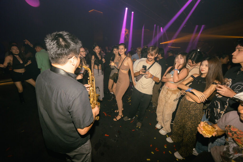 Guests on the opening night being entertained by a saxophonist