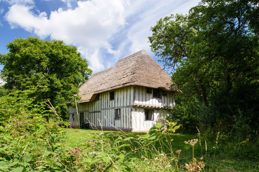 The exterior of Purton Green with its thatched roof