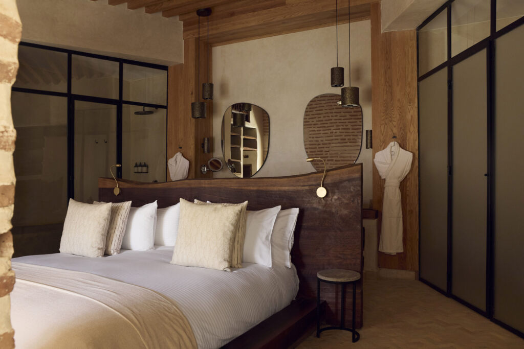 The large wooden bed inside the Royal Suite