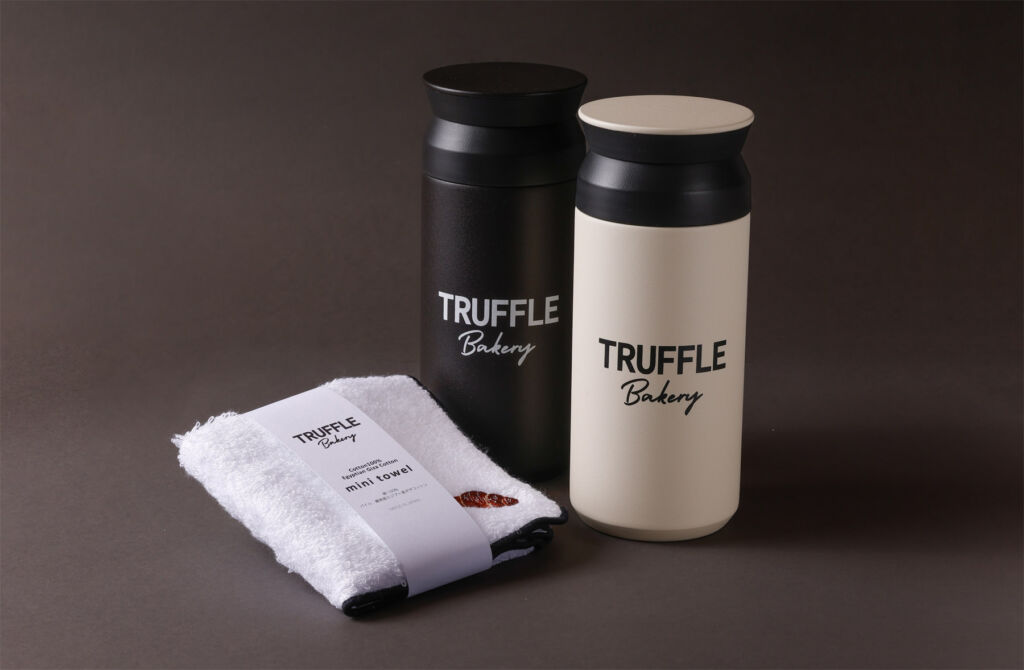 Two branded tumblers and a towel