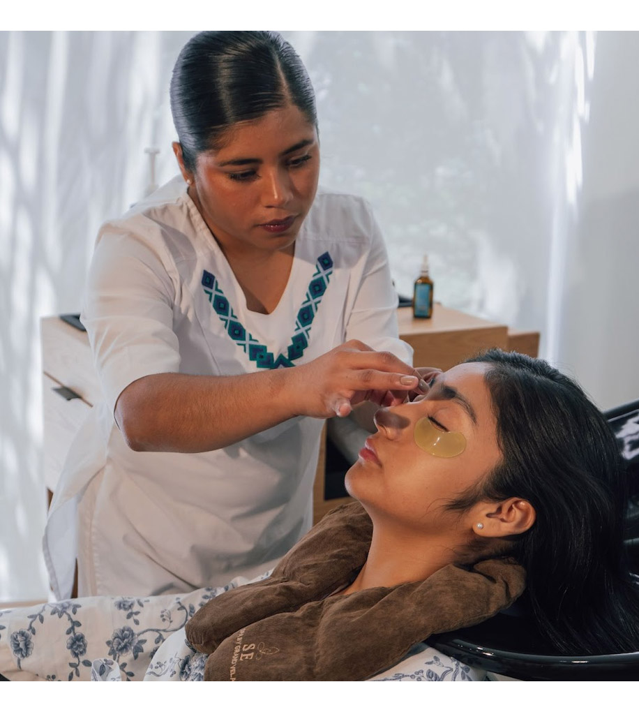 A female guest experiencing a wellness treatment on her face