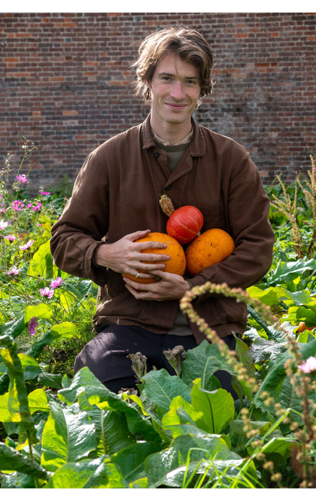 A member of the team holding freshly grown produce