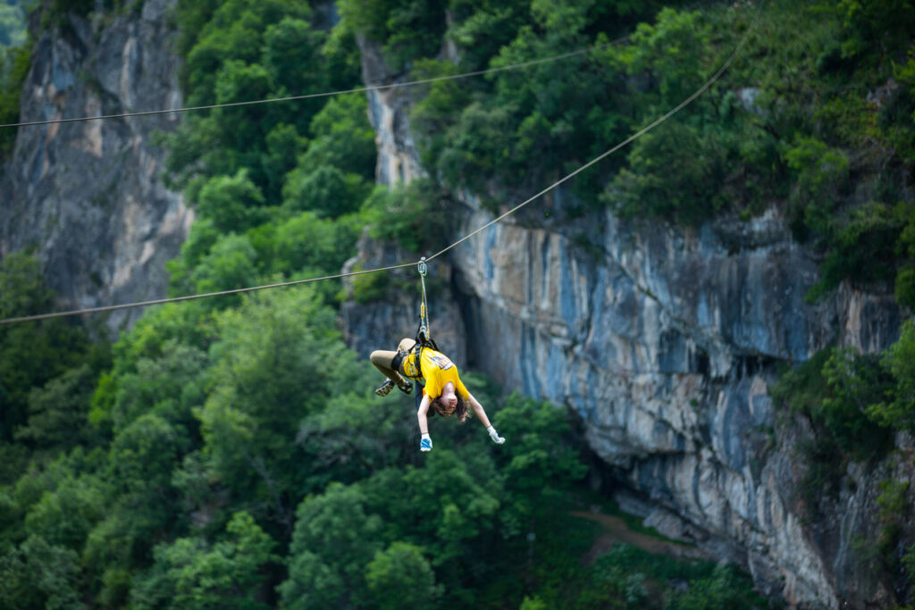 A traveller enjoying the experience of zip-lining