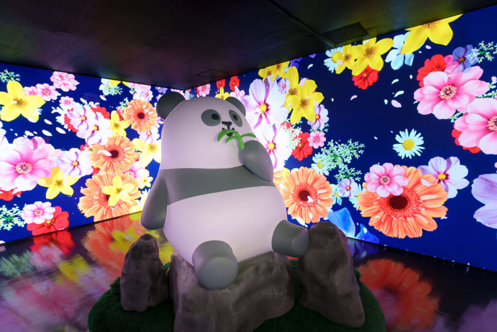 A Giant Panda sculpture in a floral themed room