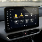 A screen inside a car showing multiple warning notifications