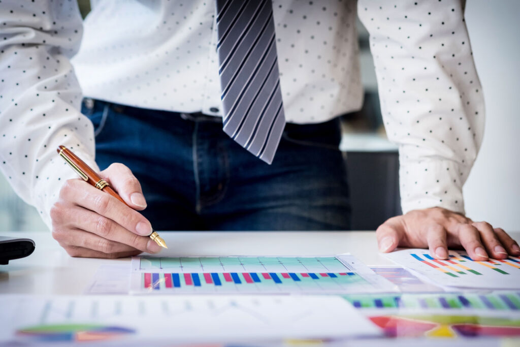 A man looking at charts on his desk