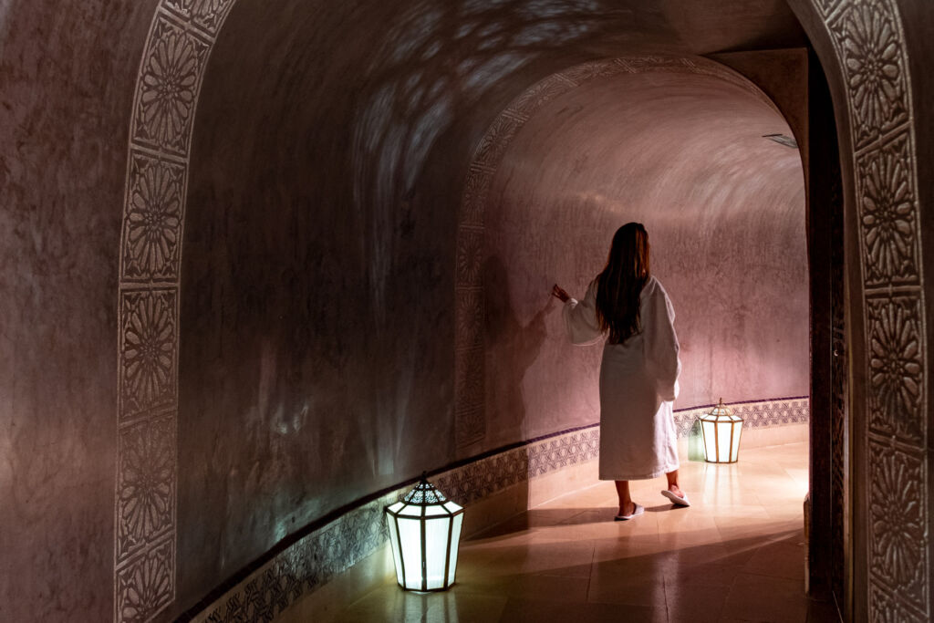 A robed female guest walking through the Spa